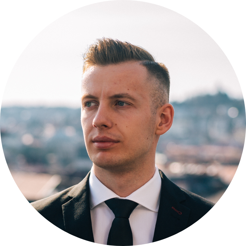 Core team member Michal Antala​ smiling in a professional setting with a neutral background